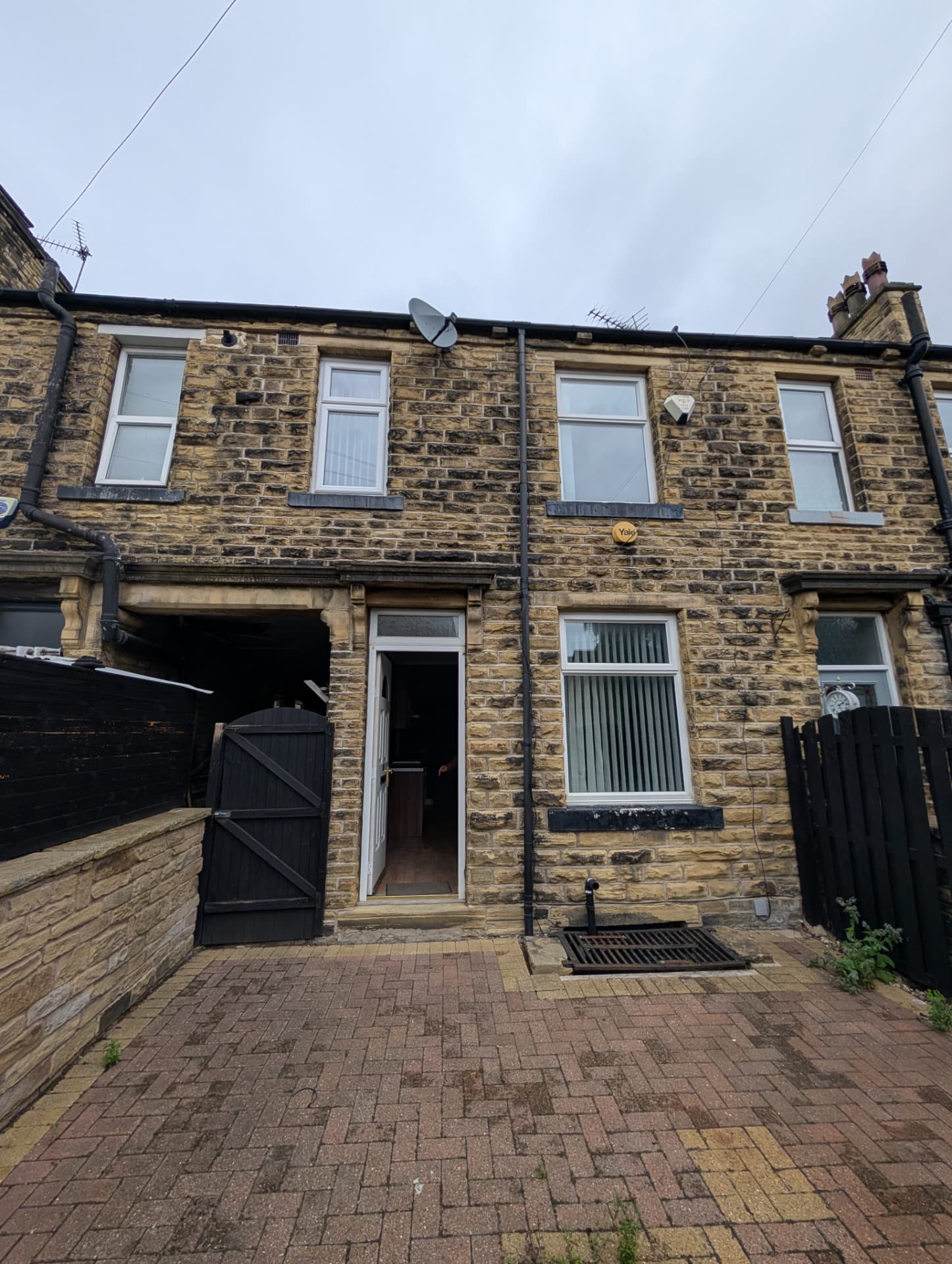 Stone terraced buy-to-let property with paved courtyard in the Leeds region